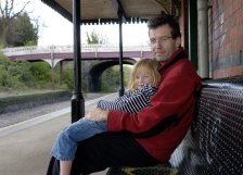 A dad and daughter waiting for the train